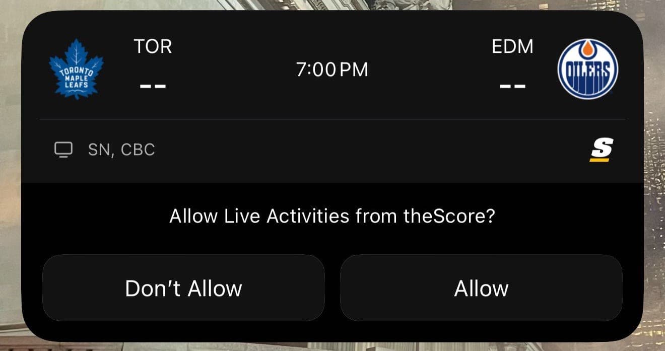 iOS permission prompt for theScore Live Activities beneath an upcoming Toronto and Edmonton hockey game